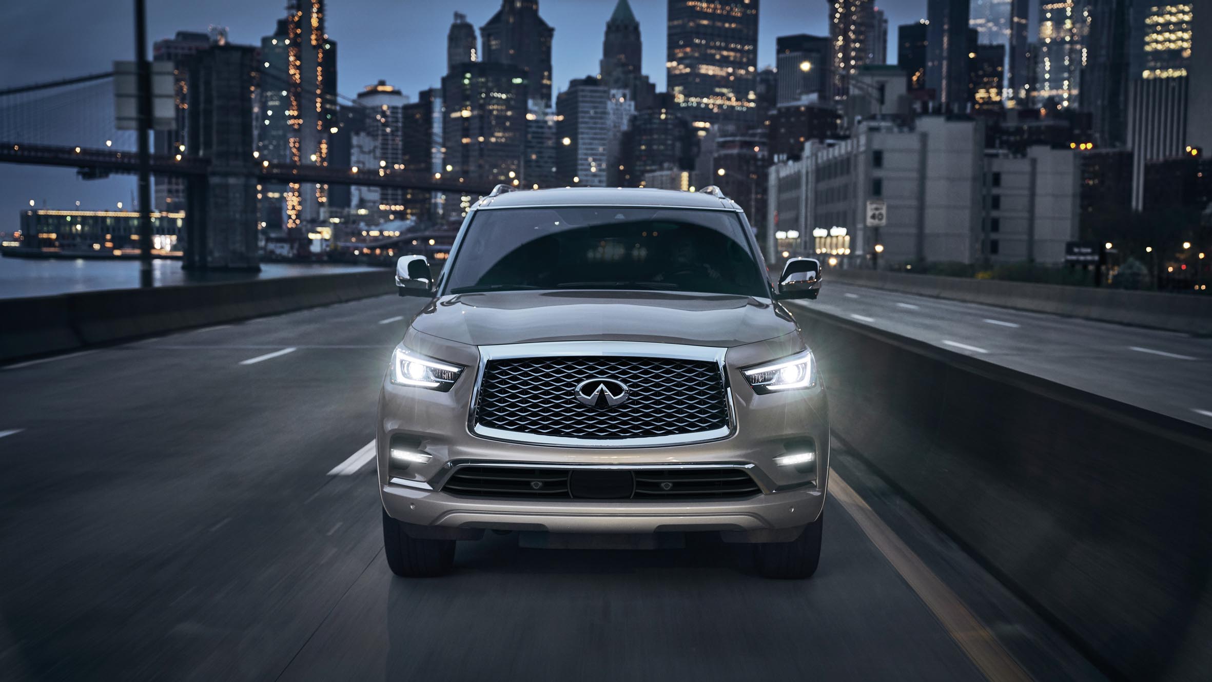 Front-view of a 2022 INFINITI QX80 SUV driving through the city.